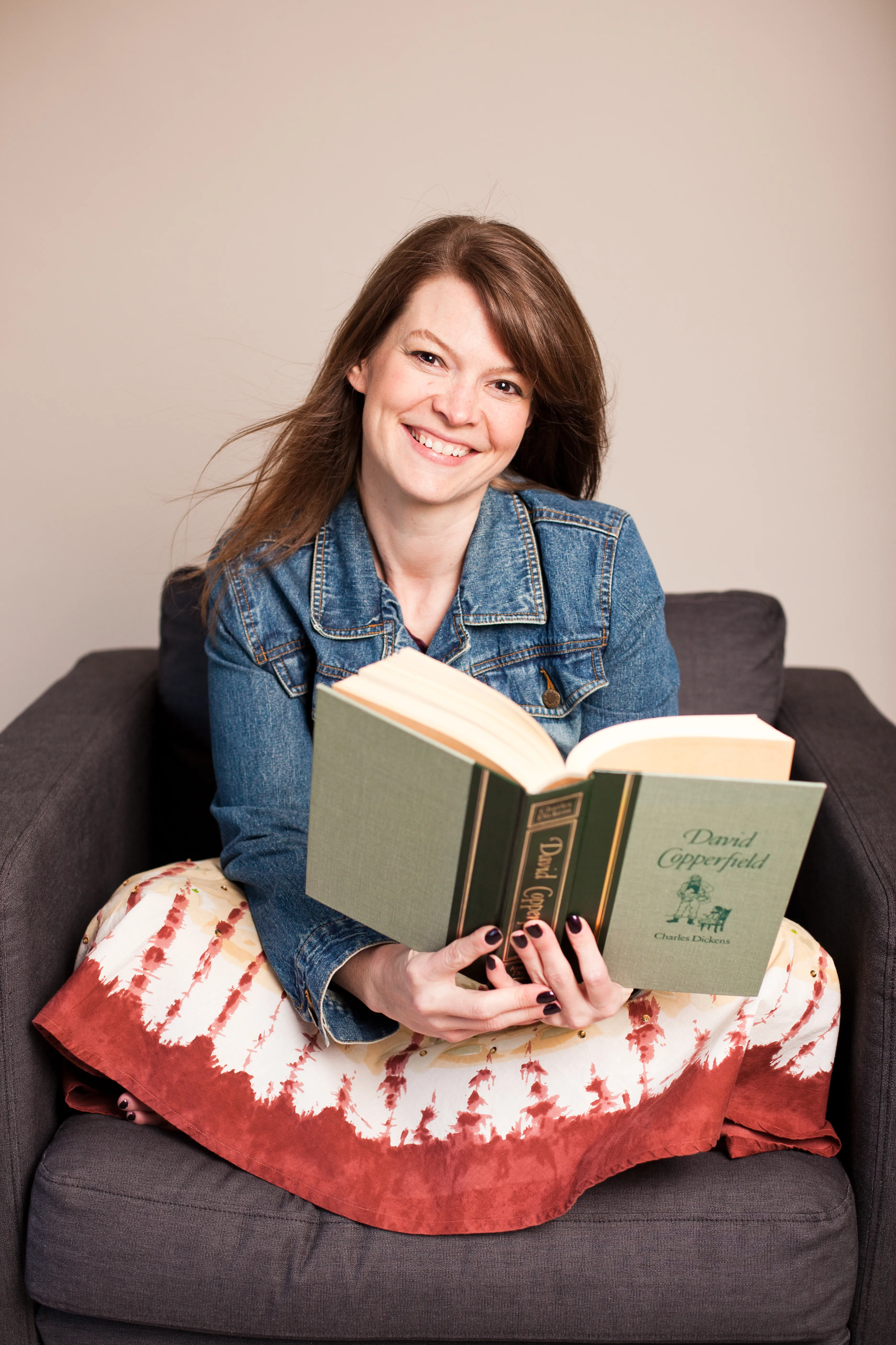 Portrait of Jessie Wiegand, sitting in a chair holding the book, David Copperfield by Charles Dickens